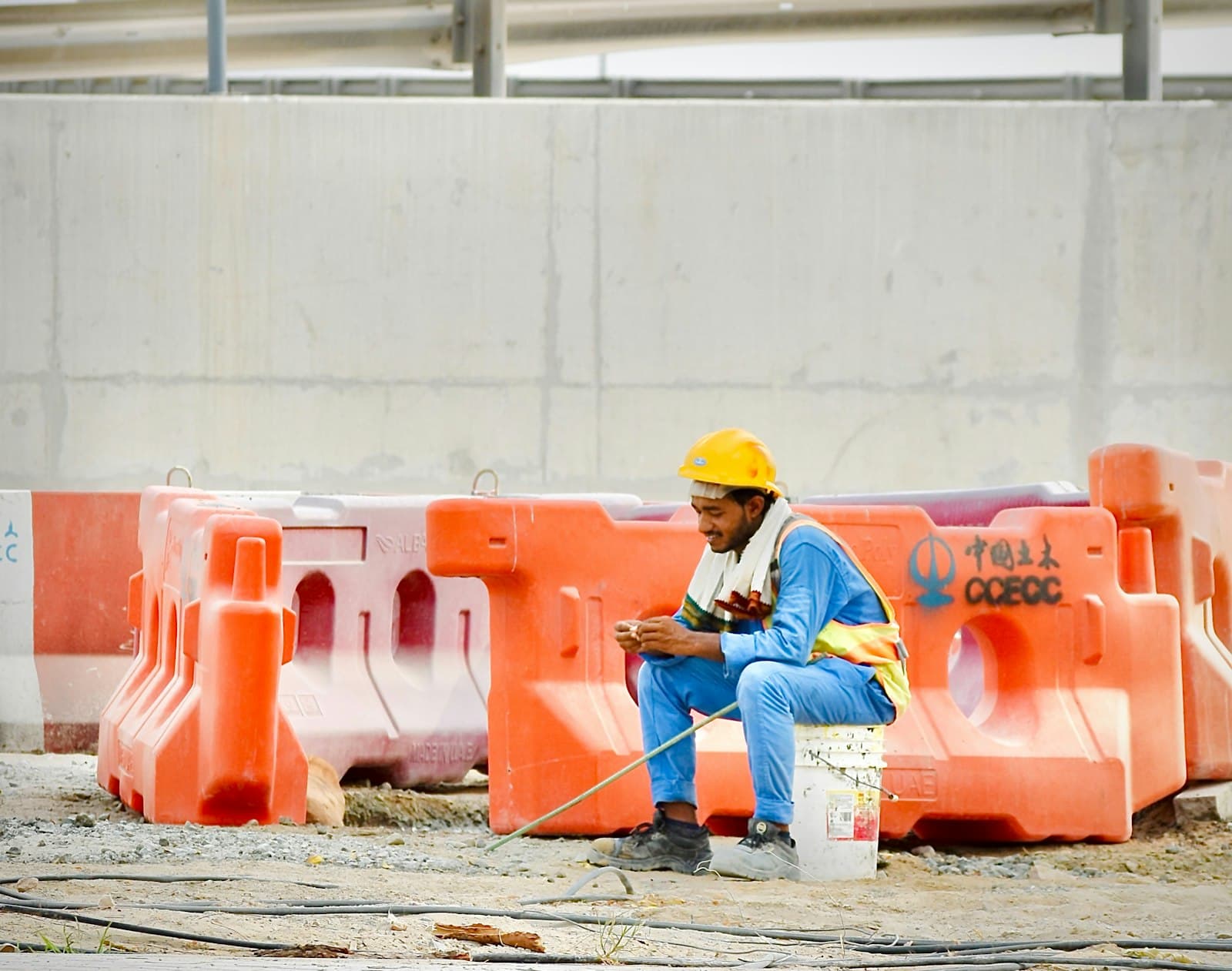 Worker in a safety harness installing equipment on a building